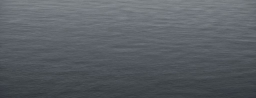 Calm open water in soft blue light